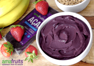 acai puree in bowl with package, granola, strawberries and bananas