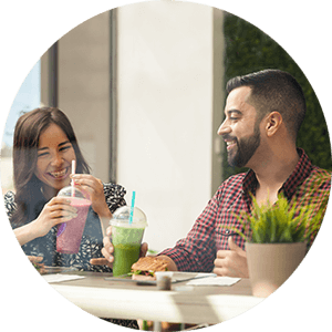 woman and man at table with smoothies