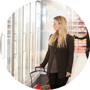 woman in front of freezer section at grocery store